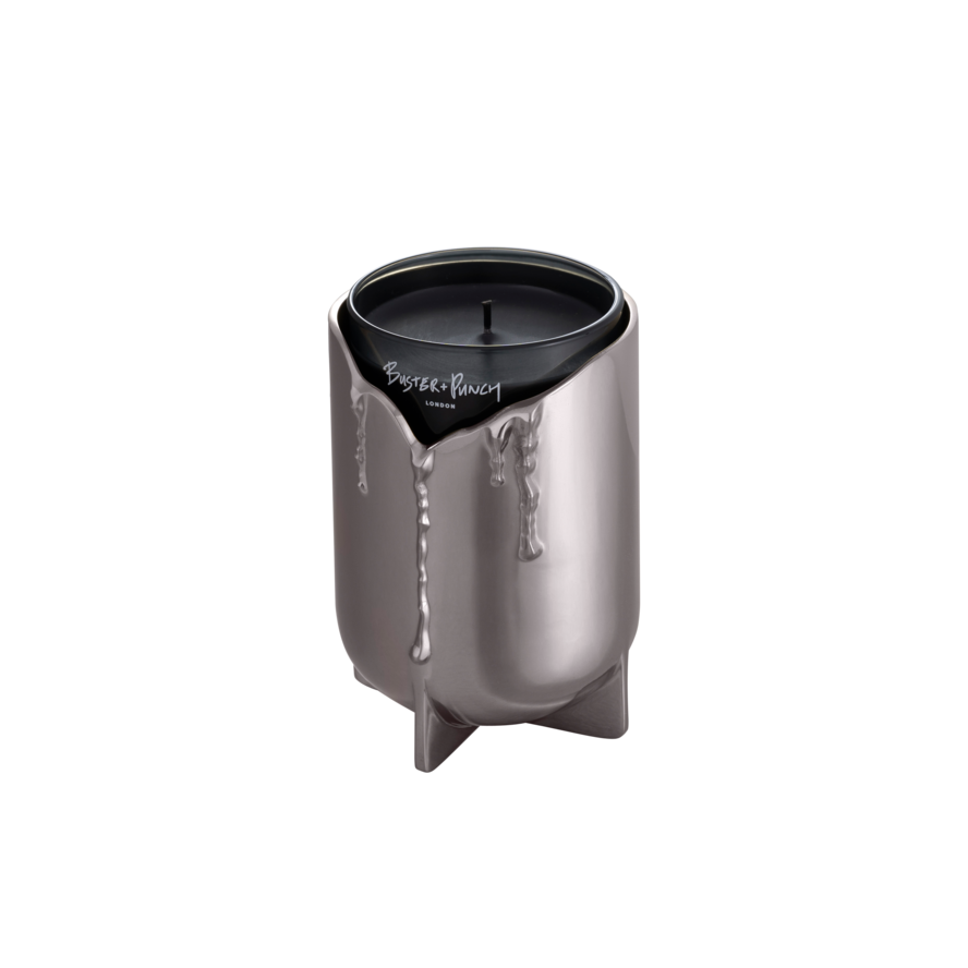 Lystage i stål med duftlys i glas, på grå baggrund.