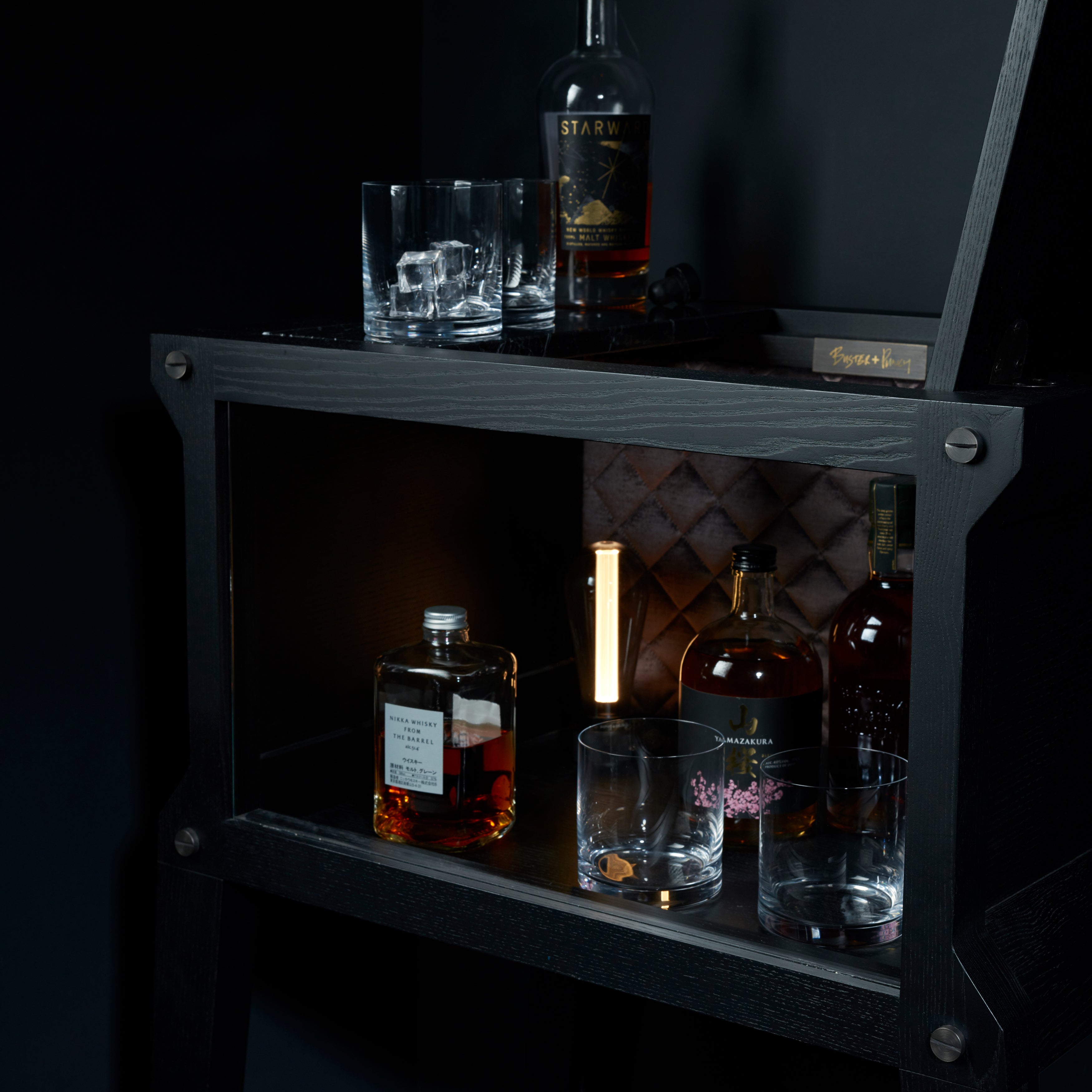 Bar i sort eg og sort marmor. Baren har en integreret lyskilde og en bordplade i sort marmor.