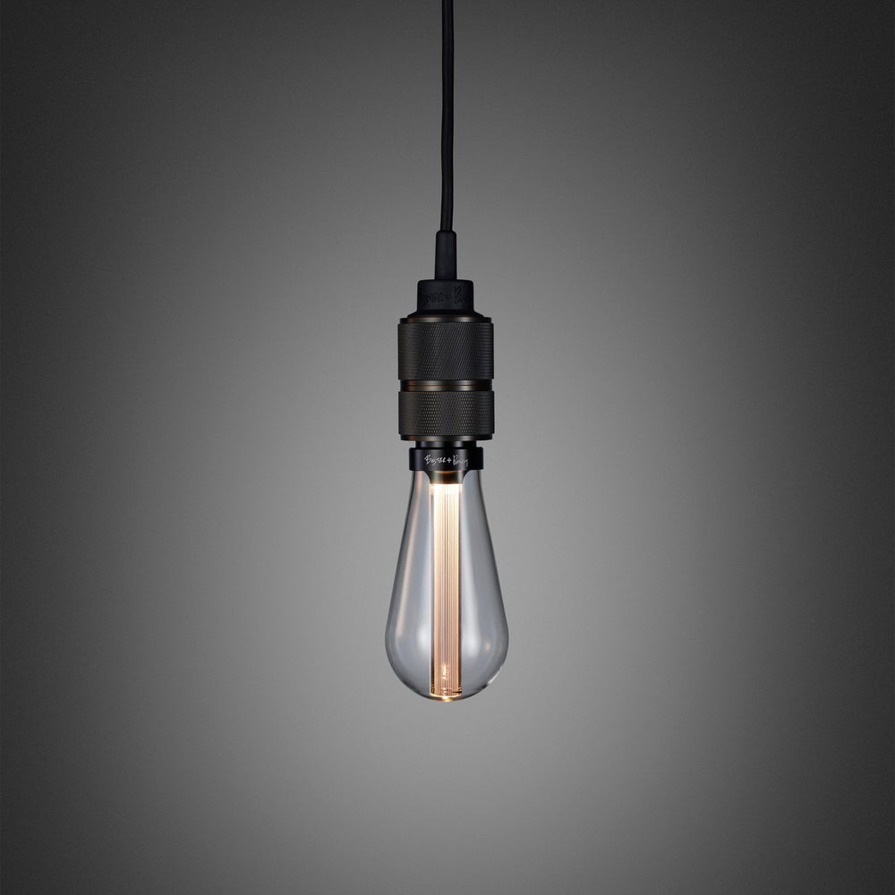 Enkel pendel lampe med fatning i bruneret massiv messing med diamond cut (cross) mønster fra Buster + Punch. Lampen har en krog i bruneret massiv messing, som gør det muligt at justere højden på lampen.